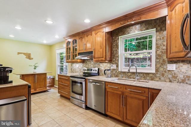 8600 Fox Run, Potomac, MD 20854 - kitchen featuring appliances with stainless steel finishes, under cabinet range hood, light tile patterned flooring, backsplash, and recessed lighting
