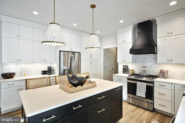 105 Fading Way, York, PA 17406 - kitchen featuring appliances with stainless steel finishes, custom range hood, white cabinets, light countertops, and recessed lighting