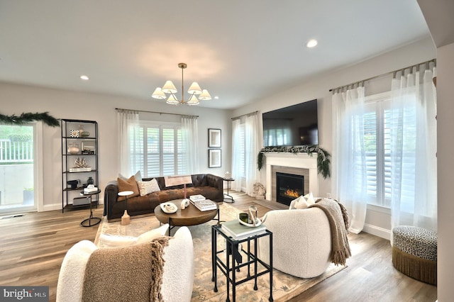 105 Fading Way, York, PA 17406 - living area with a chandelier, wood finished floors, a glass covered fireplace, and recessed lighting