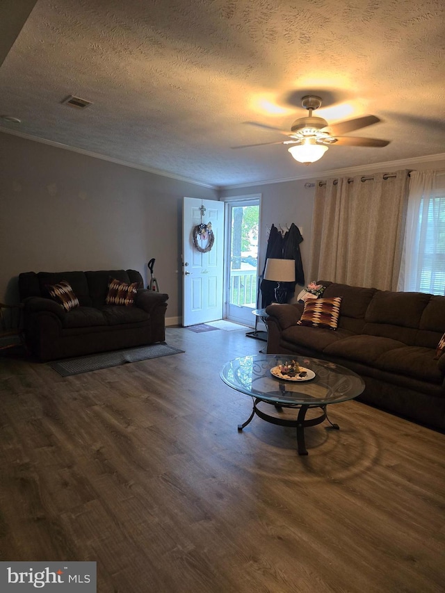2800 Wakefield St, Colonial Beach, VA 22443 - living area featuring a textured ceiling, dark wood finished floors, a ceiling fan, ornamental molding, and baseboards