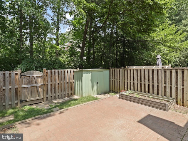 9664 Masterworks Dr, Vienna, VA 22181 - fenced backyard with a shed, a gate, a patio, and a garden