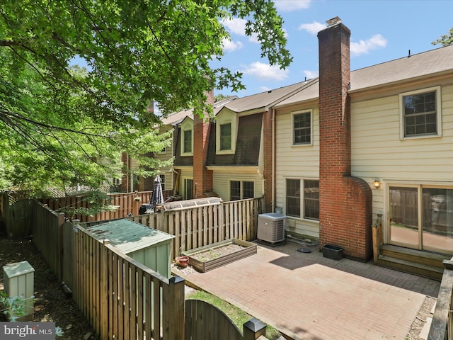 9664 Masterworks Dr, Vienna, VA 22181 - rear view of house with a deck and a chimney