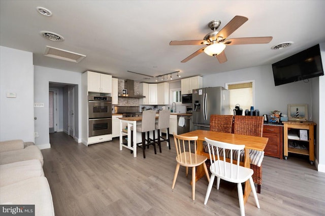 1312 Tuggies Rd, Pasadena, MD 21122 - dining space with attic access, track lighting, light wood finished floors, and a ceiling fan