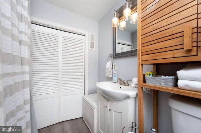 1312 Tuggies Rd, Pasadena, MD 21122 - full bath featuring vanity, wood finished floors, and a closet