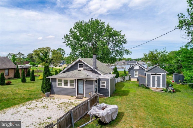 1312 Tuggies Rd, Pasadena, MD 21122 - back of property featuring a chimney and a shingled roof
