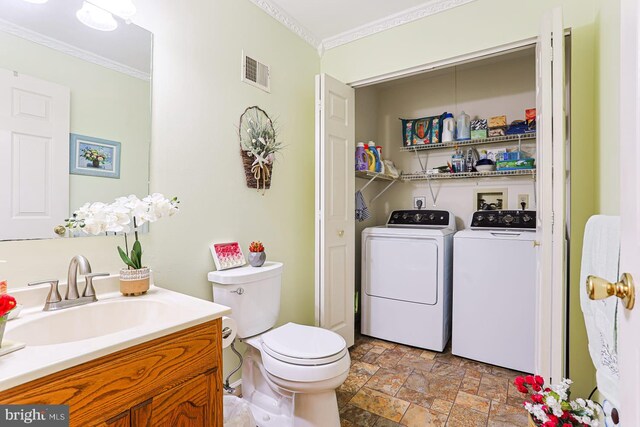1027 Fredrick Blvd, Reading, PA 19605 - bathroom featuring crown molding, stone finish flooring, independent washer and dryer, vanity, and toilet