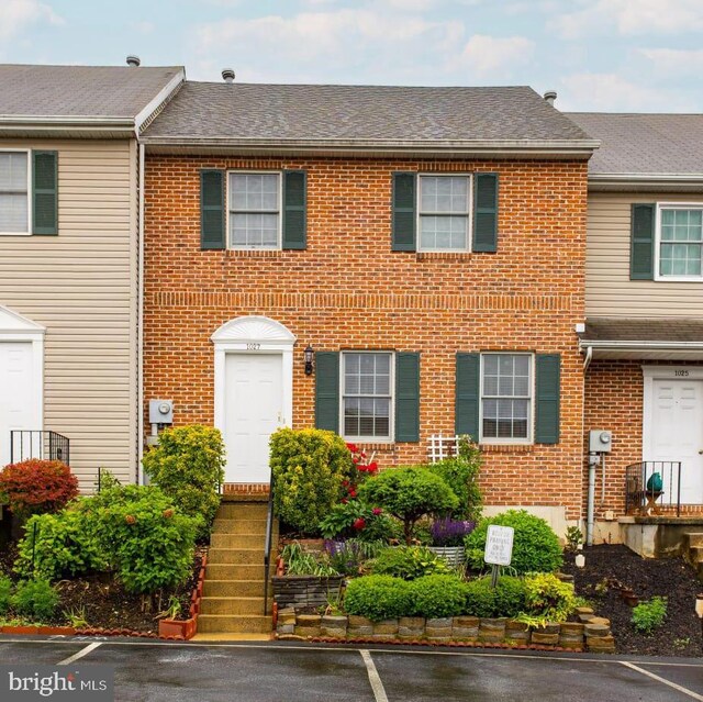 1027 Fredrick Blvd, Reading, PA 19605 - townhome / multi-family property featuring brick siding, uncovered parking, and roof with shingles