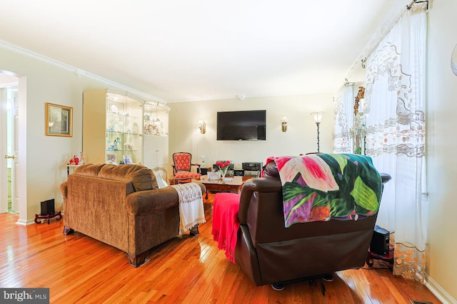1027 Fredrick Blvd, Reading, PA 19605 - living room with light wood finished floors, ornamental molding, and baseboards