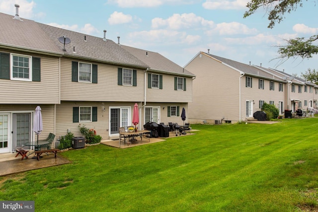 1027 Fredrick Blvd, Reading, PA 19605 - rear view of property featuring a patio, a lawn, and central air condition unit