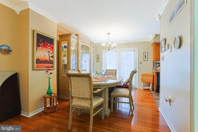1027 Fredrick Blvd, Reading, PA 19605 - dining space featuring a chandelier, ornamental molding, hardwood / wood-style flooring, and baseboards