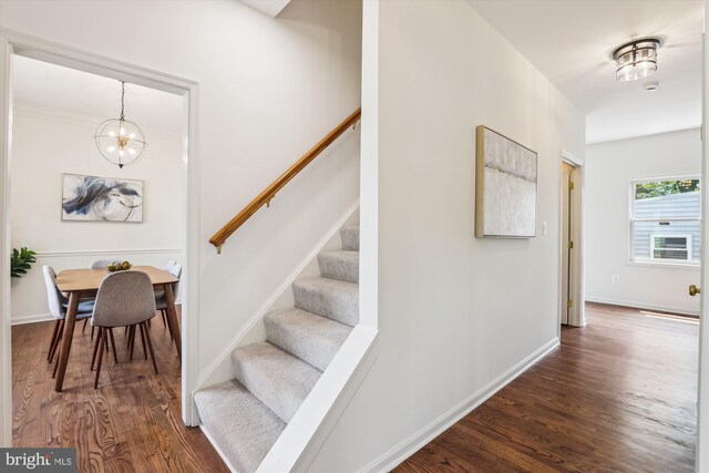 2142 N Dinwiddie St, Arlington, VA 22207 - stairway featuring wood finished floors and a chandelier