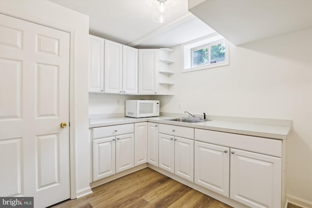 2142 N Dinwiddie St, Arlington, VA 22207 - kitchen featuring white microwave, white cabinetry, light wood finished floors, and open shelves