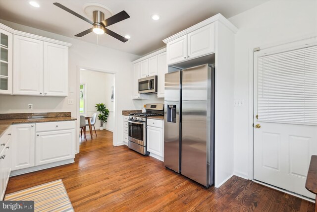 2142 N Dinwiddie St, Arlington, VA 22207 - kitchen featuring stainless steel appliances, white cabinets, wood finished floors, glass insert cabinets, and a ceiling fan