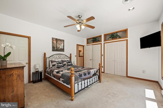 734 Log Cabin Ln, Berkeley Springs, WV 25411 - bedroom with multiple closets, light carpet, baseboards, and ceiling fan