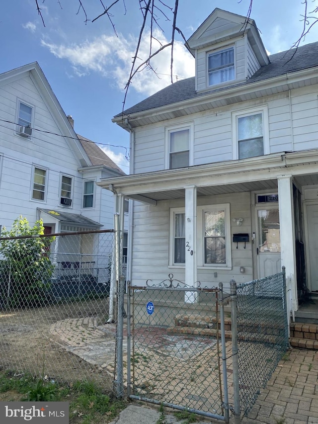 220 N 3rd St, Millville, NJ 08332 - view of front of property with a gate, a fenced front yard, and covered porch