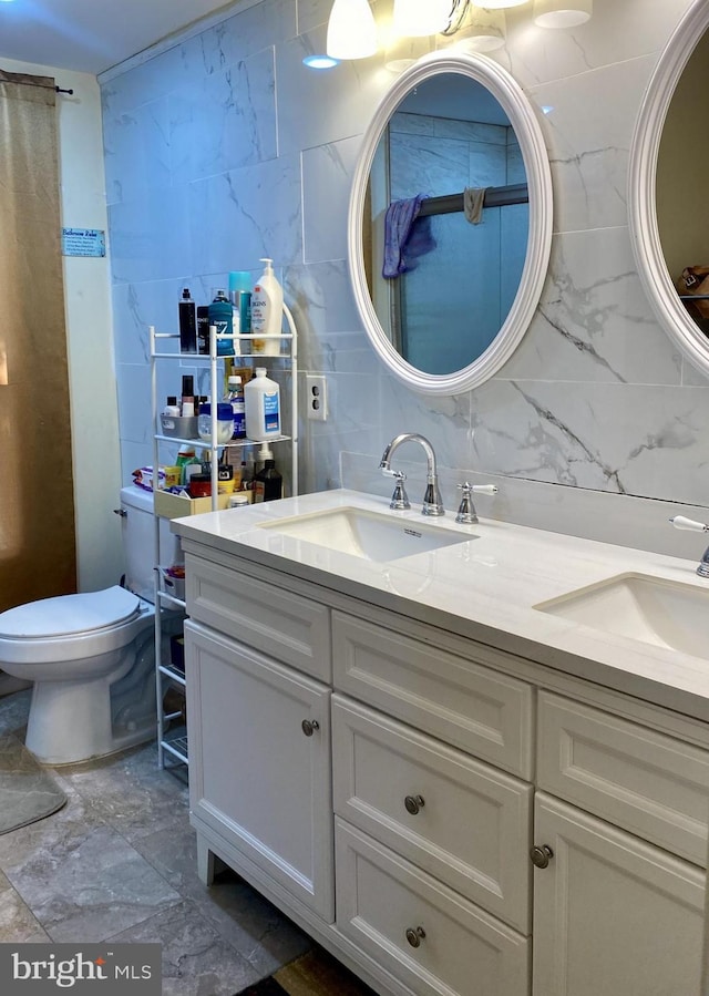 220 N 3rd St, Millville, NJ 08332 - bathroom featuring tile walls, double vanity, marble finish flooring, toilet, and tasteful backsplash