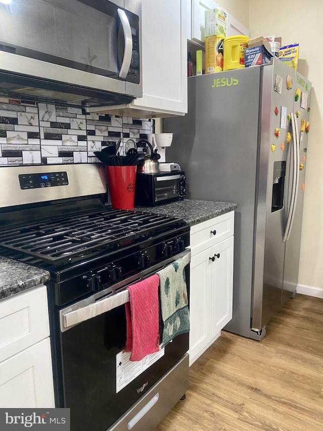 220 N 3rd St, Millville, NJ 08332 - kitchen with stainless steel appliances, white cabinetry, light wood-style floors, and baseboards