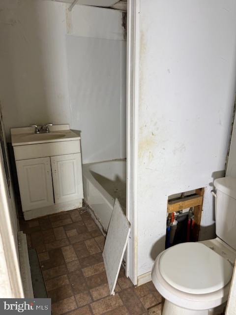 600 Keystone Ave Unit 63, Darby, PA 19023 - bathroom featuring toilet, vanity, bathing tub / shower combination, and brick patterned flooring