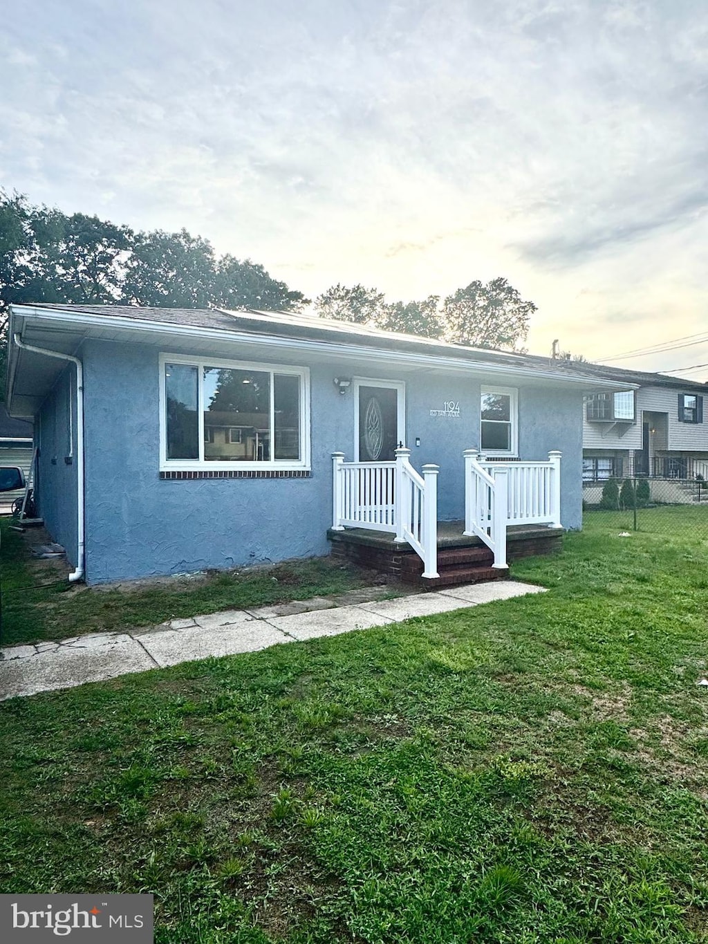 1194 Red Bank Ave, West Deptford, NJ 08086 - view of front of house featuring stucco siding and a yard