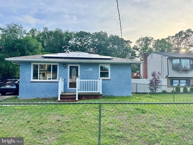 1194 Red Bank Ave, West Deptford, NJ 08086 - view of front of home featuring stucco siding and roof mounted solar panels
