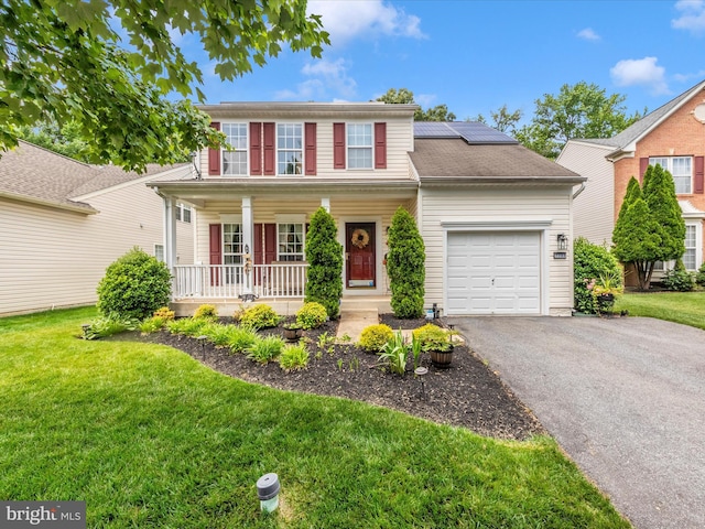 7732 Rotherham Dr, Hanover, MD 21076 - view of front facade featuring a porch, a garage, a front yard, roof mounted solar panels, and driveway