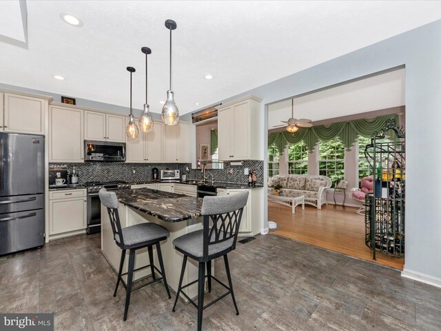 7732 Rotherham Dr, Hanover, MD 21076 - kitchen with stainless steel appliances, a breakfast bar, backsplash, recessed lighting, and a center island