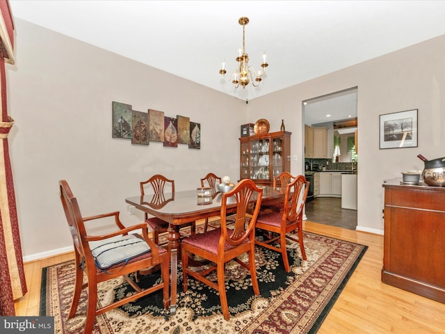 7732 Rotherham Dr, Hanover, MD 21076 - dining area with a chandelier and light wood-style floors