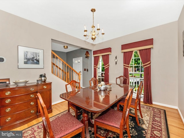 7732 Rotherham Dr, Hanover, MD 21076 - dining room featuring light wood-style flooring, a chandelier, and stairs