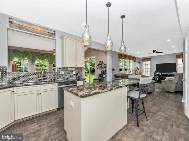 7732 Rotherham Dr, Hanover, MD 21076 - kitchen with stainless steel dishwasher, a ceiling fan, a kitchen island, a breakfast bar area, and recessed lighting