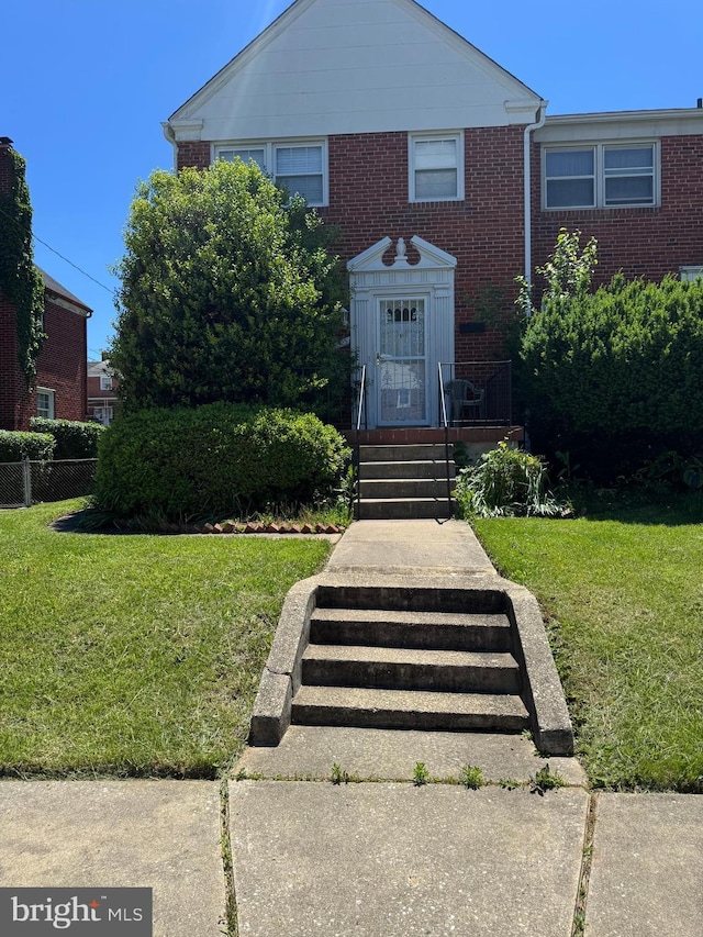 1525 Clairidge Rd, Baltimore, MD 21207 - view of front facade featuring a front lawn and brick siding