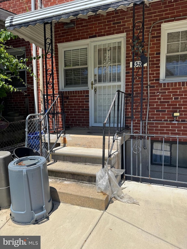 1525 Clairidge Rd, Baltimore, MD 21207 - doorway to property featuring brick siding and covered porch