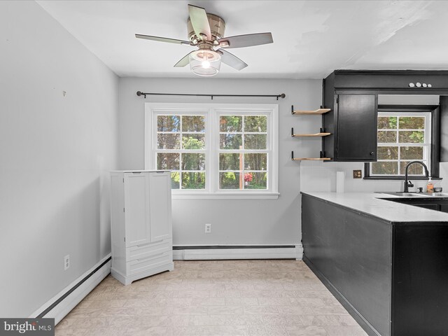 1002 Sherwood Cir, Salisbury, MD 21804 - kitchen with a baseboard heating unit, dark cabinets, and plenty of natural light