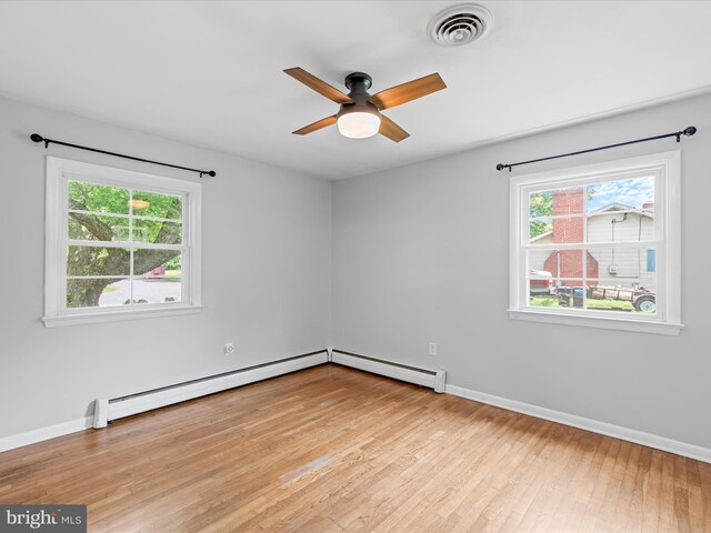 1002 Sherwood Cir, Salisbury, MD 21804 - empty room with baseboard heating, a ceiling fan, a baseboard radiator, and light wood-style floors