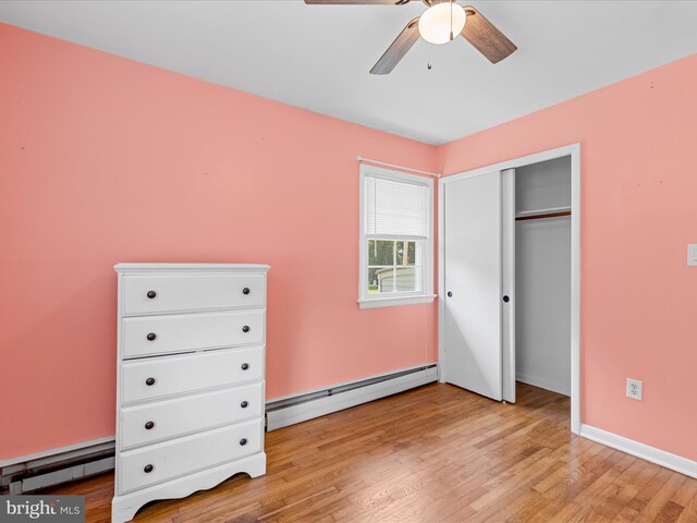 1002 Sherwood Cir, Salisbury, MD 21804 - unfurnished bedroom featuring baseboard heating, a baseboard radiator, light wood-type flooring, and a closet