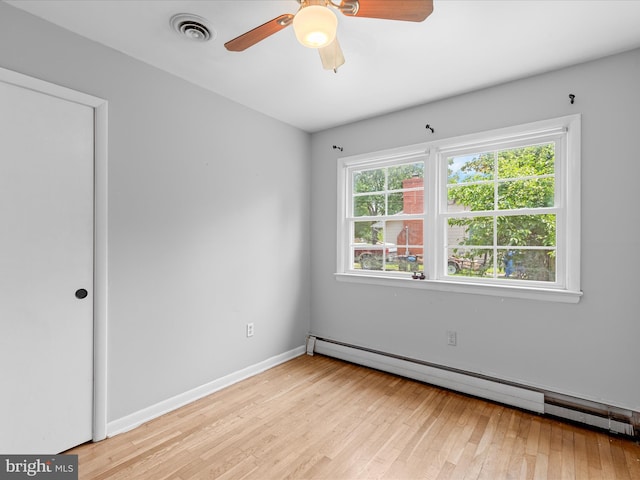 1002 Sherwood Cir, Salisbury, MD 21804 - spare room featuring baseboard heating, light wood finished floors, and a ceiling fan