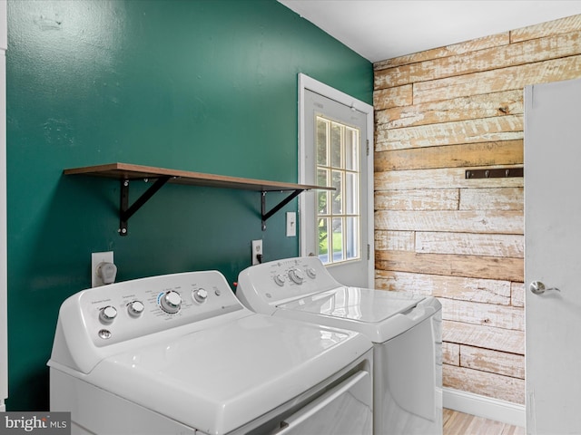 1002 Sherwood Cir, Salisbury, MD 21804 - laundry area featuring wood walls, washing machine and clothes dryer, and wood finished floors