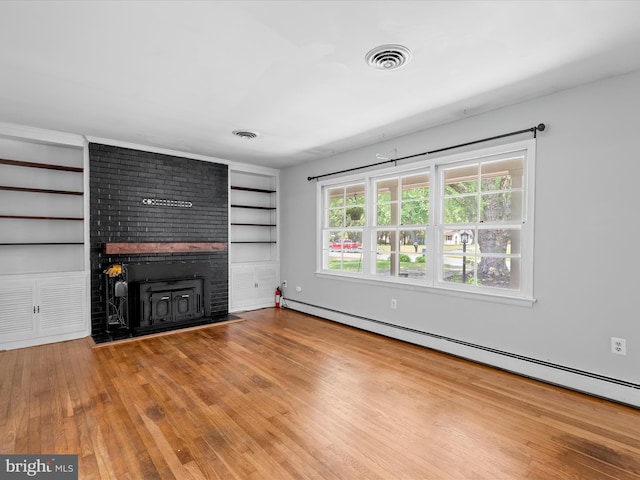 1002 Sherwood Cir, Salisbury, MD 21804 - unfurnished living room with a baseboard heating unit, a fireplace, built in features, and wood finished floors