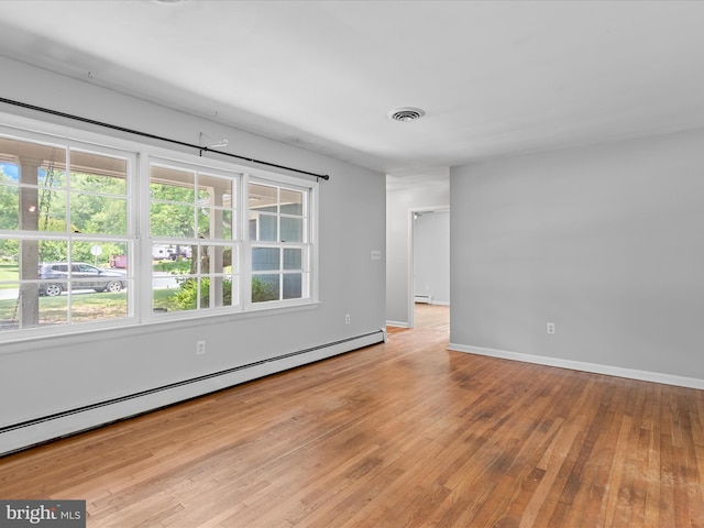 1002 Sherwood Cir, Salisbury, MD 21804 - empty room with baseboard heating, healthy amount of natural light, and hardwood / wood-style floors