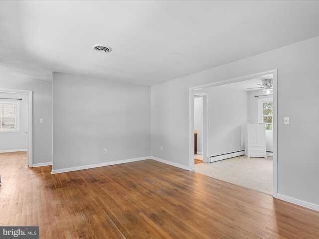 1002 Sherwood Cir, Salisbury, MD 21804 - empty room with a baseboard heating unit, hardwood / wood-style flooring, and a ceiling fan