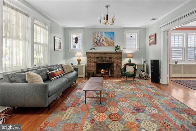 6721 Piney Branch Rd NW, Washington, DC 20012 - living room with wood finished floors, a chandelier, and a fireplace
