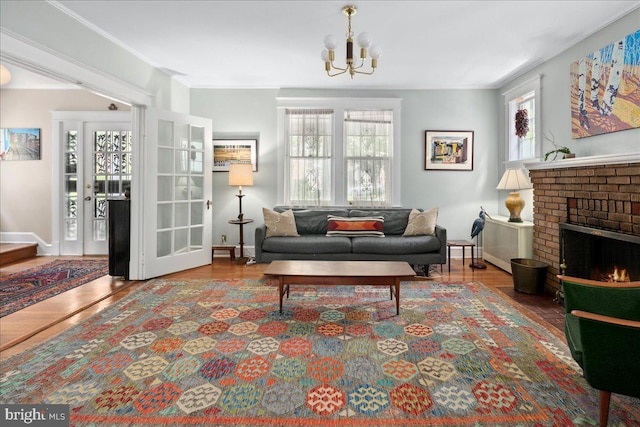 6721 Piney Branch Rd NW, Washington, DC 20012 - living room featuring wood finished floors, a chandelier, baseboards, and a brick fireplace