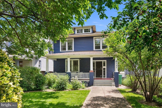 6721 Piney Branch Rd NW, Washington, DC 20012 - american foursquare style home featuring a porch, brick siding, and a front lawn
