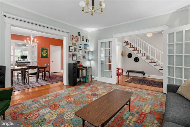 6721 Piney Branch Rd NW, Washington, DC 20012 - living area featuring a chandelier, wood finished floors, crown molding, stairway, and french doors