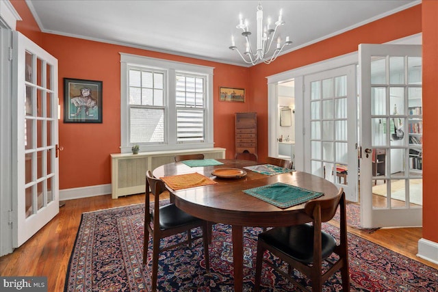 6721 Piney Branch Rd NW, Washington, DC 20012 - dining room with french doors, a chandelier, radiator heating unit, wood finished floors, and crown molding