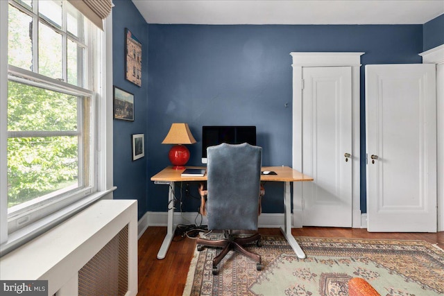 6721 Piney Branch Rd NW, Washington, DC 20012 - office area featuring wood finished floors, baseboards, and radiator heating unit