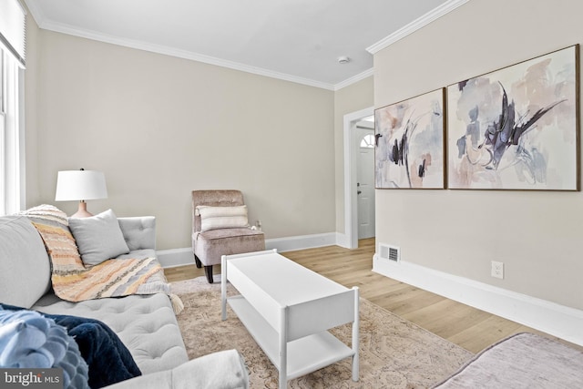 3414 Old York Rd, Baltimore, MD 21218 - living room featuring crown molding, light wood-style flooring, and baseboards