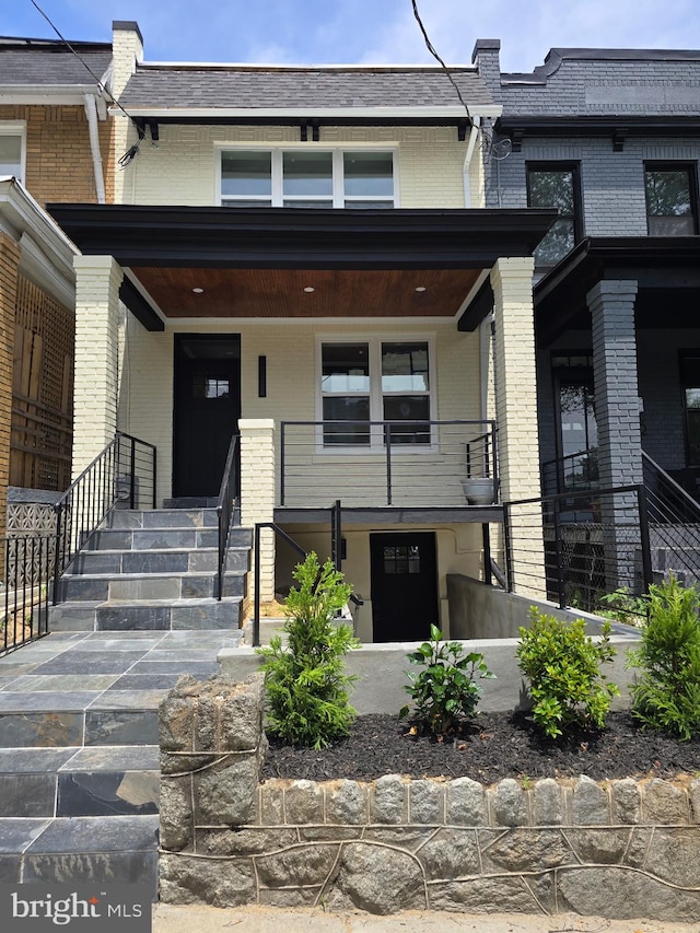 815 Marietta Pl NW, Washington, DC 20011 - view of front of home with brick siding, covered porch, and mansard roof