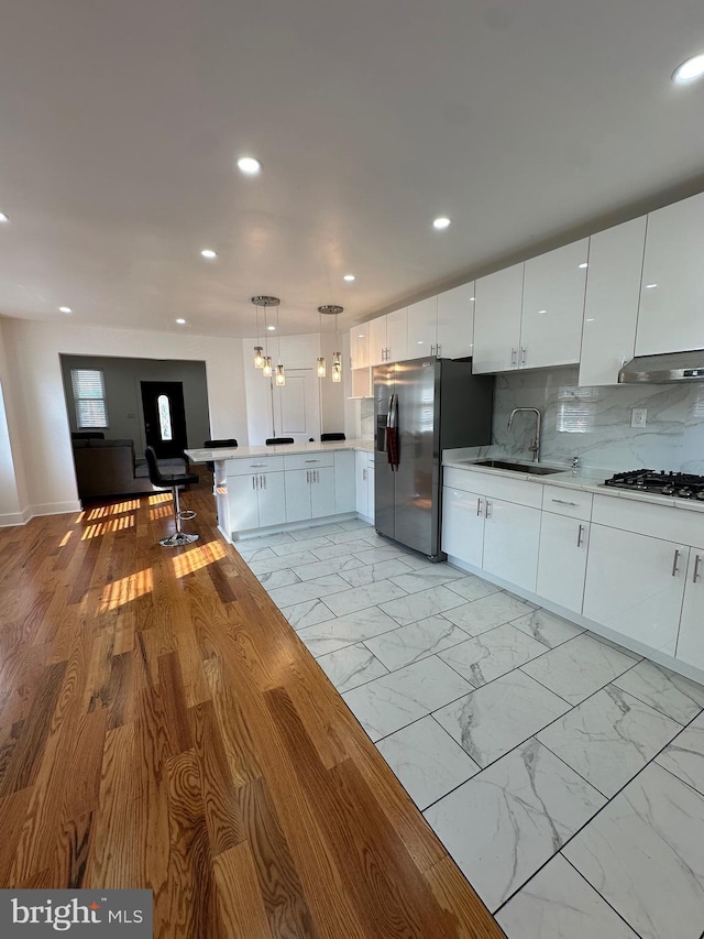 528 E Cheltenham Ave, Philadelphia, PA 19120 - kitchen with appliances with stainless steel finishes, a peninsula, ventilation hood, recessed lighting, and a sink