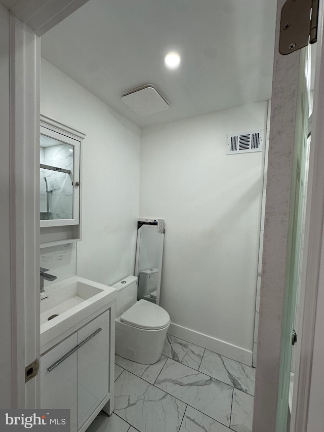 528 E Cheltenham Ave, Philadelphia, PA 19120 - bathroom featuring marble finish flooring, vanity, toilet, baseboards, and recessed lighting