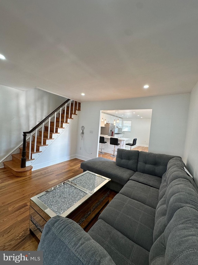 528 E Cheltenham Ave, Philadelphia, PA 19120 - living room featuring stairs, wood finished floors, recessed lighting, baseboards, and a chandelier
